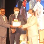 Dr. Hemanta Nath receiving award for excellance in state election service from Prof. Jagdish Muhkhi